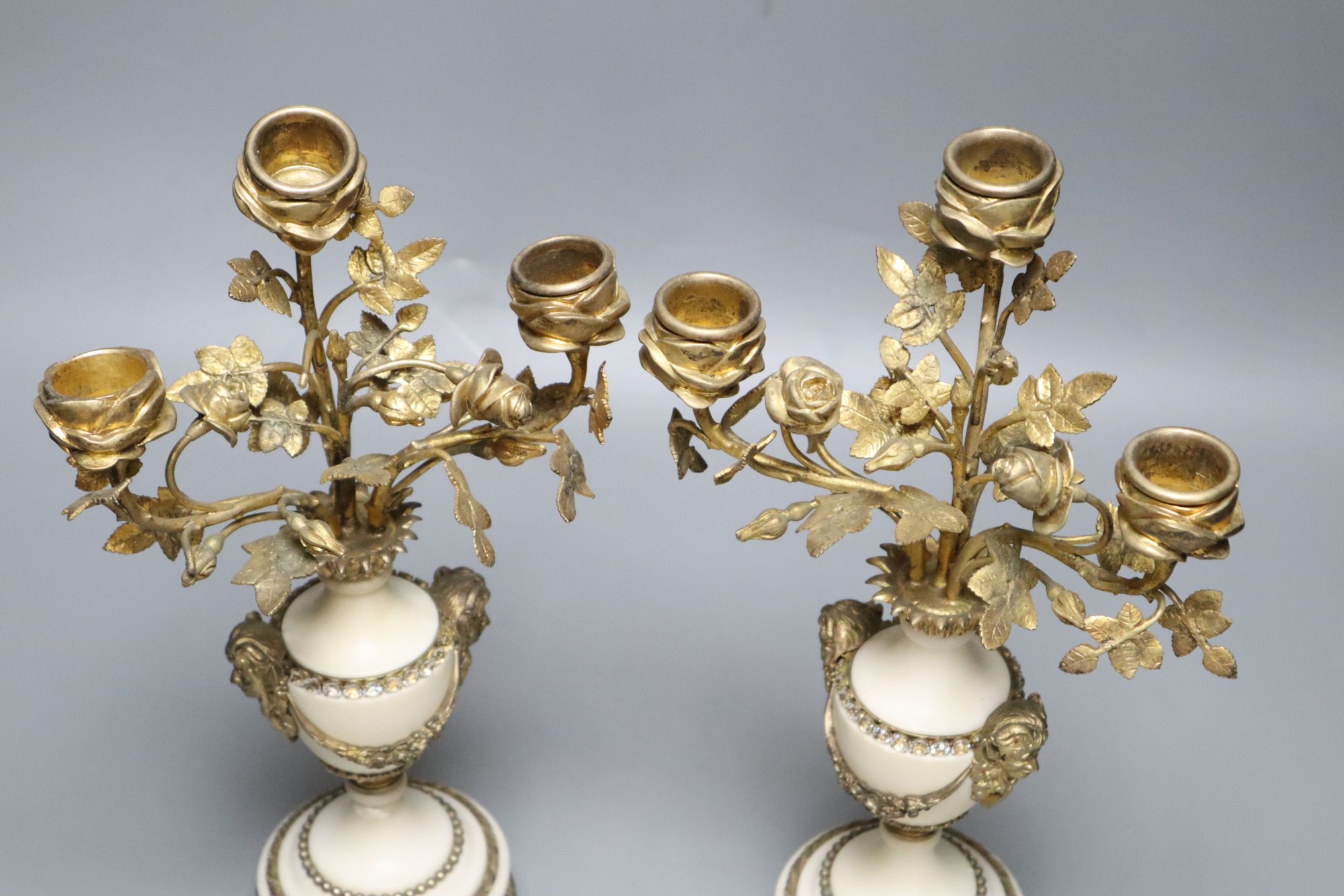 A pair of gilt metal and alabaster three branch candelabra, height 31cm (one a.f.)